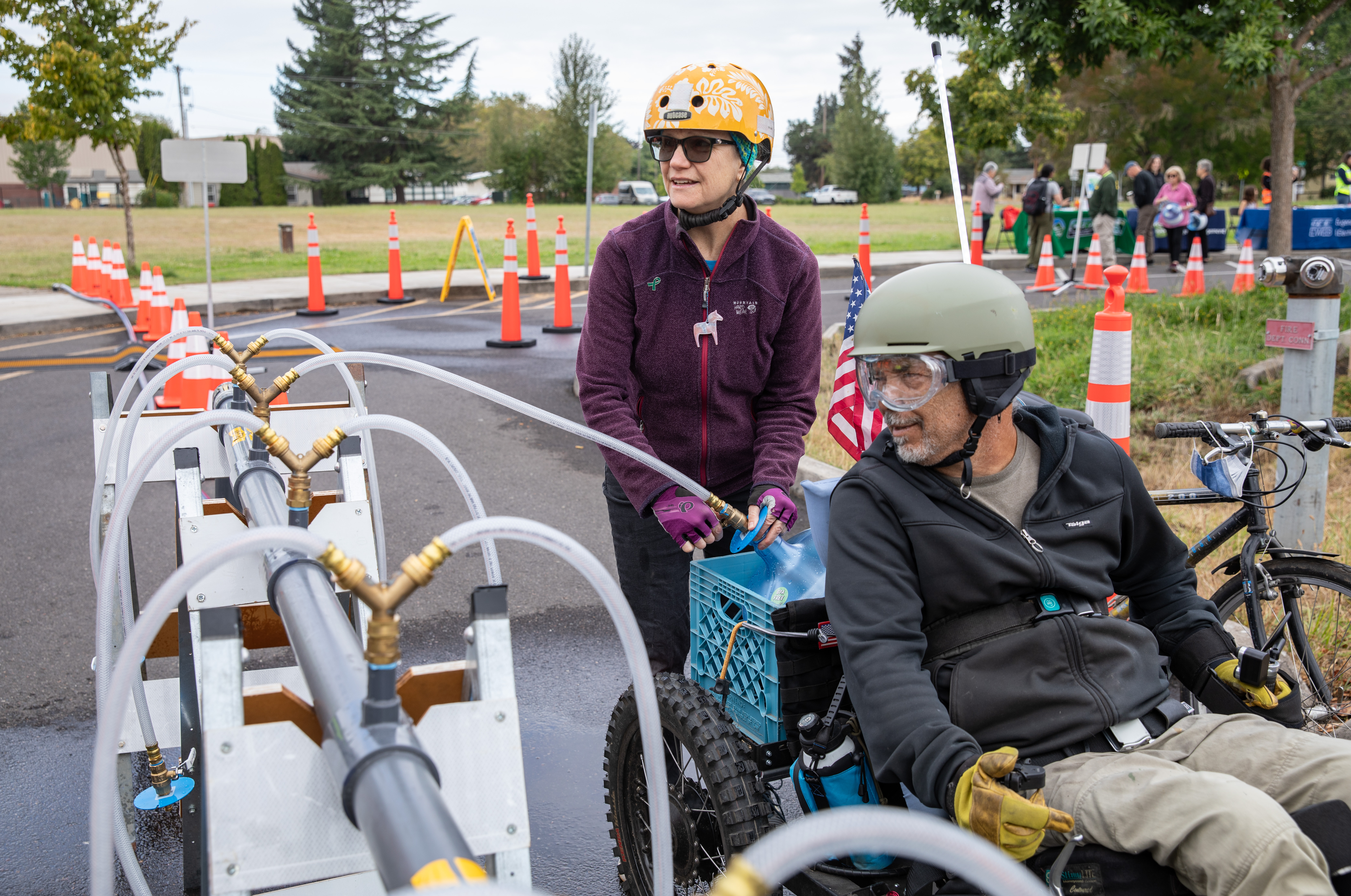 Community members fill up emergency water container at Howard Elementary School Emergency Water Station 