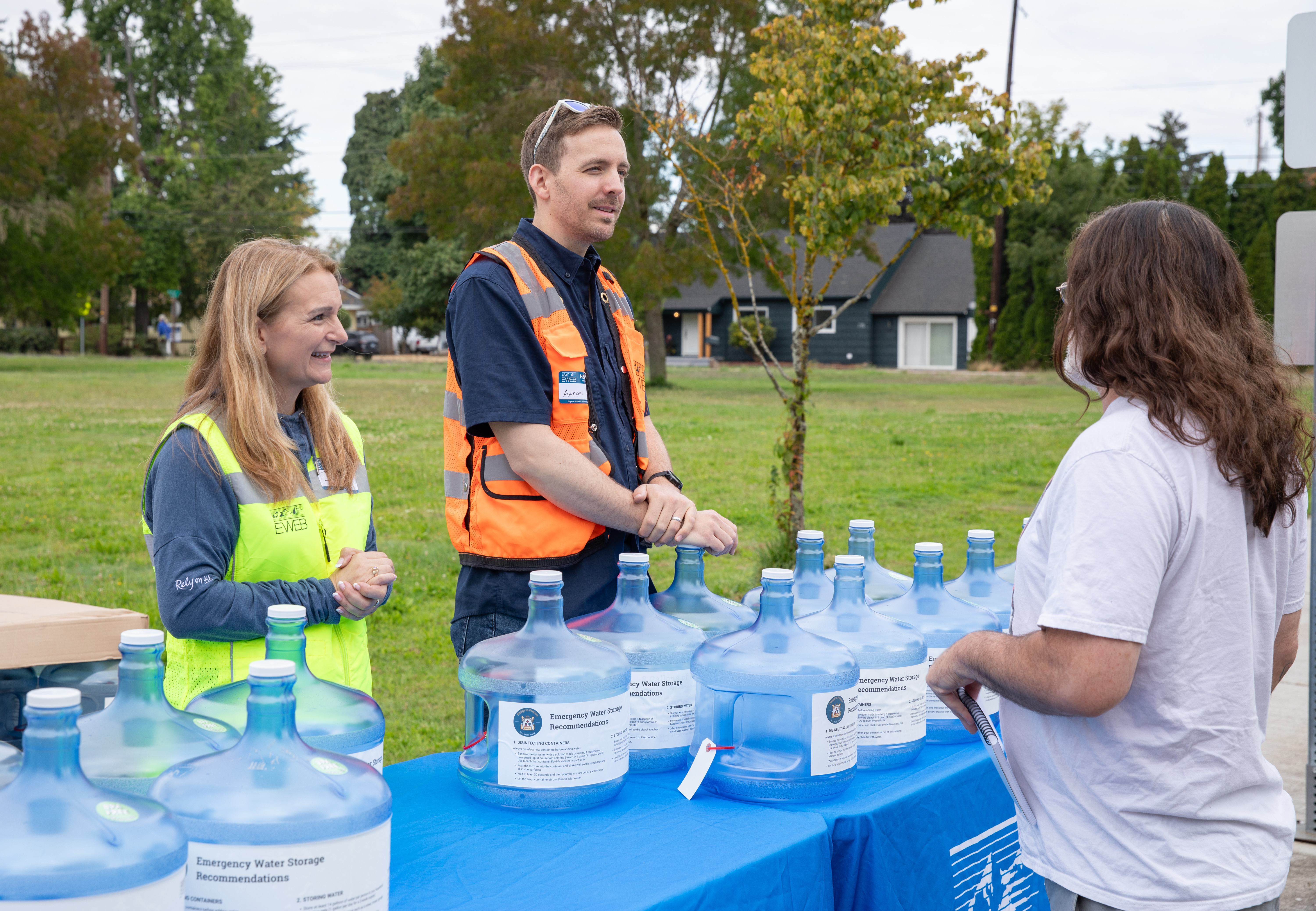 EWEB Staff hand out emergency water containers to community members