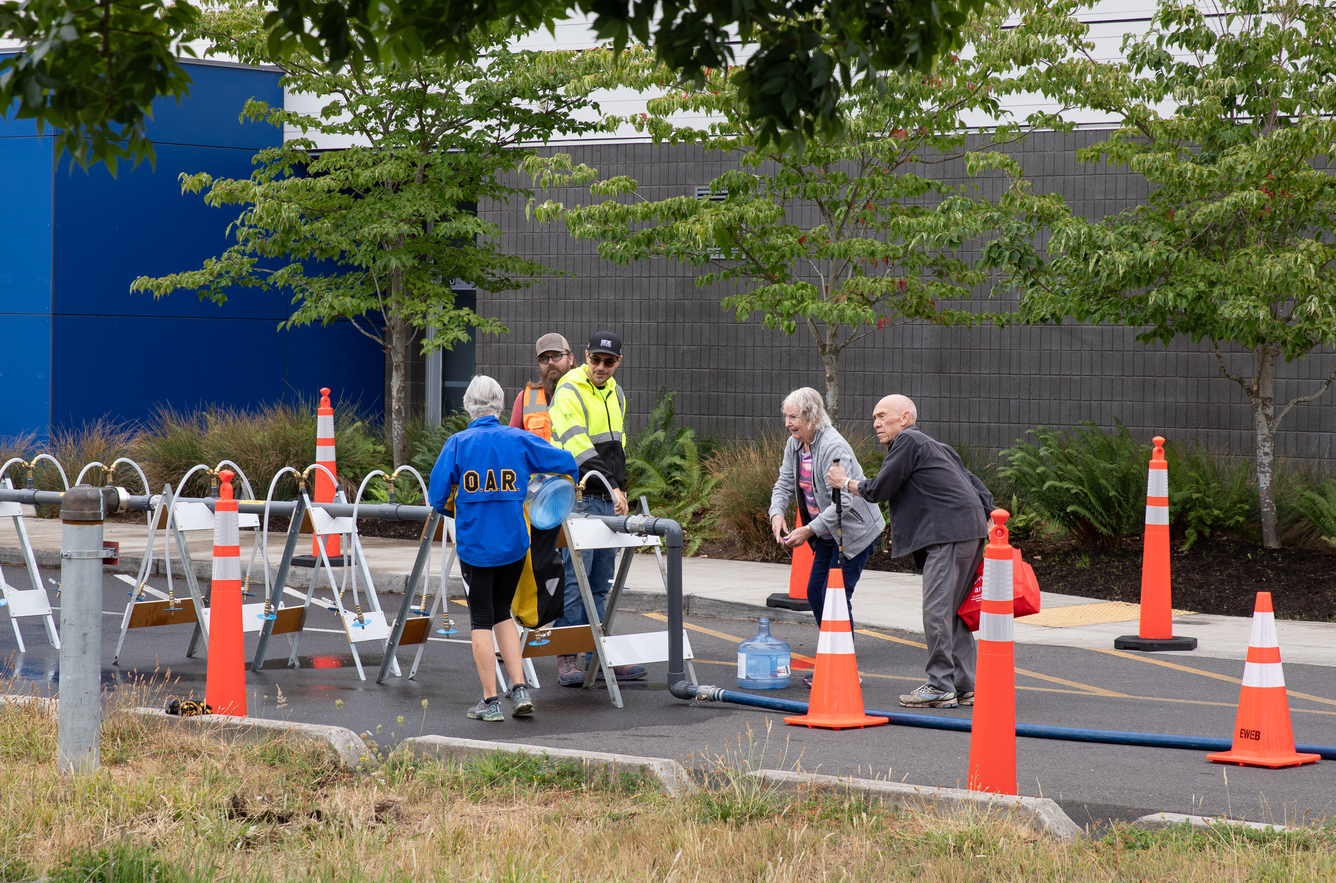 River Road community members practice filling emergcy water containers.