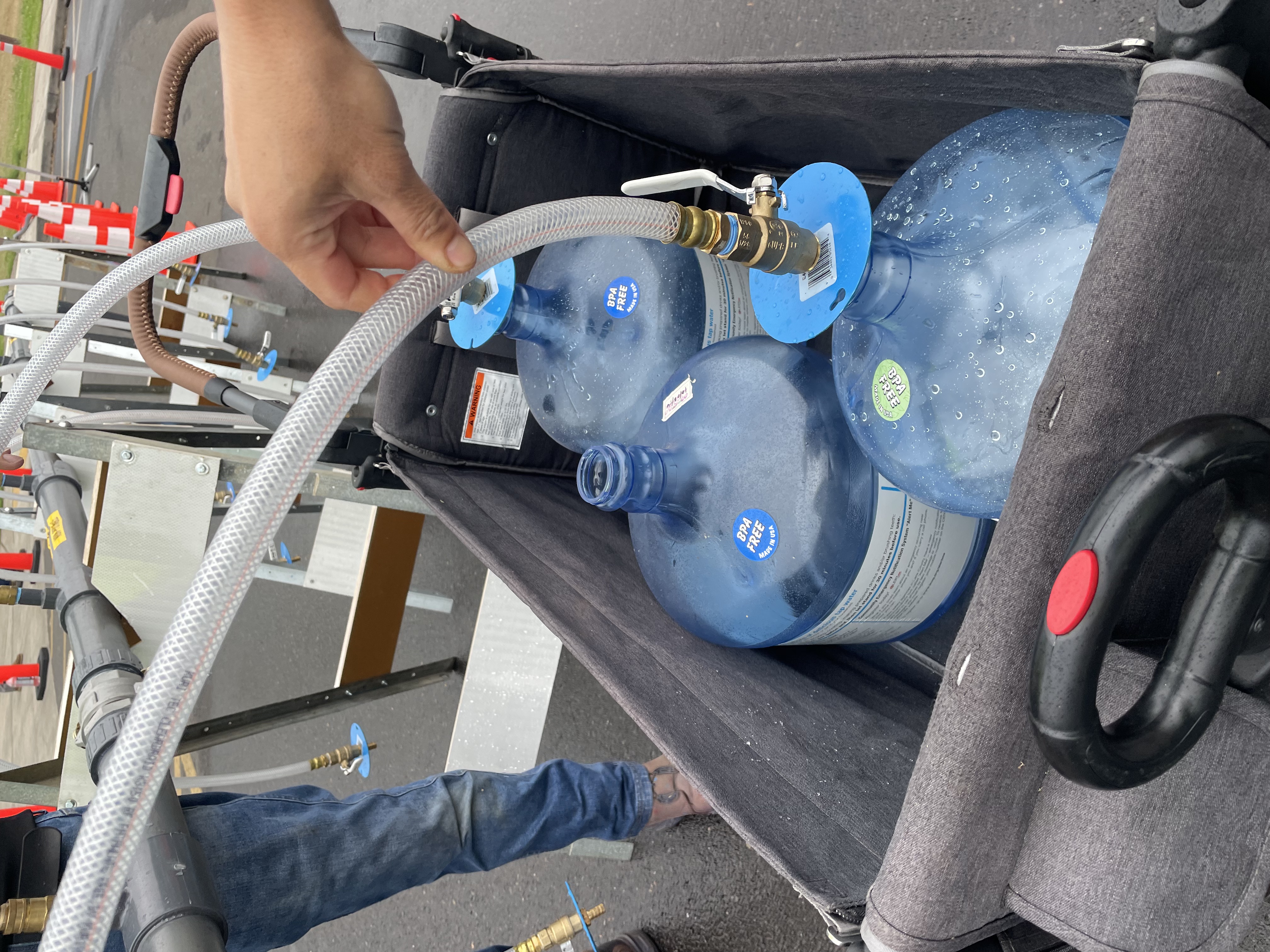 Wagon full of emergency water containers is filled at Emergency Water Station Open house