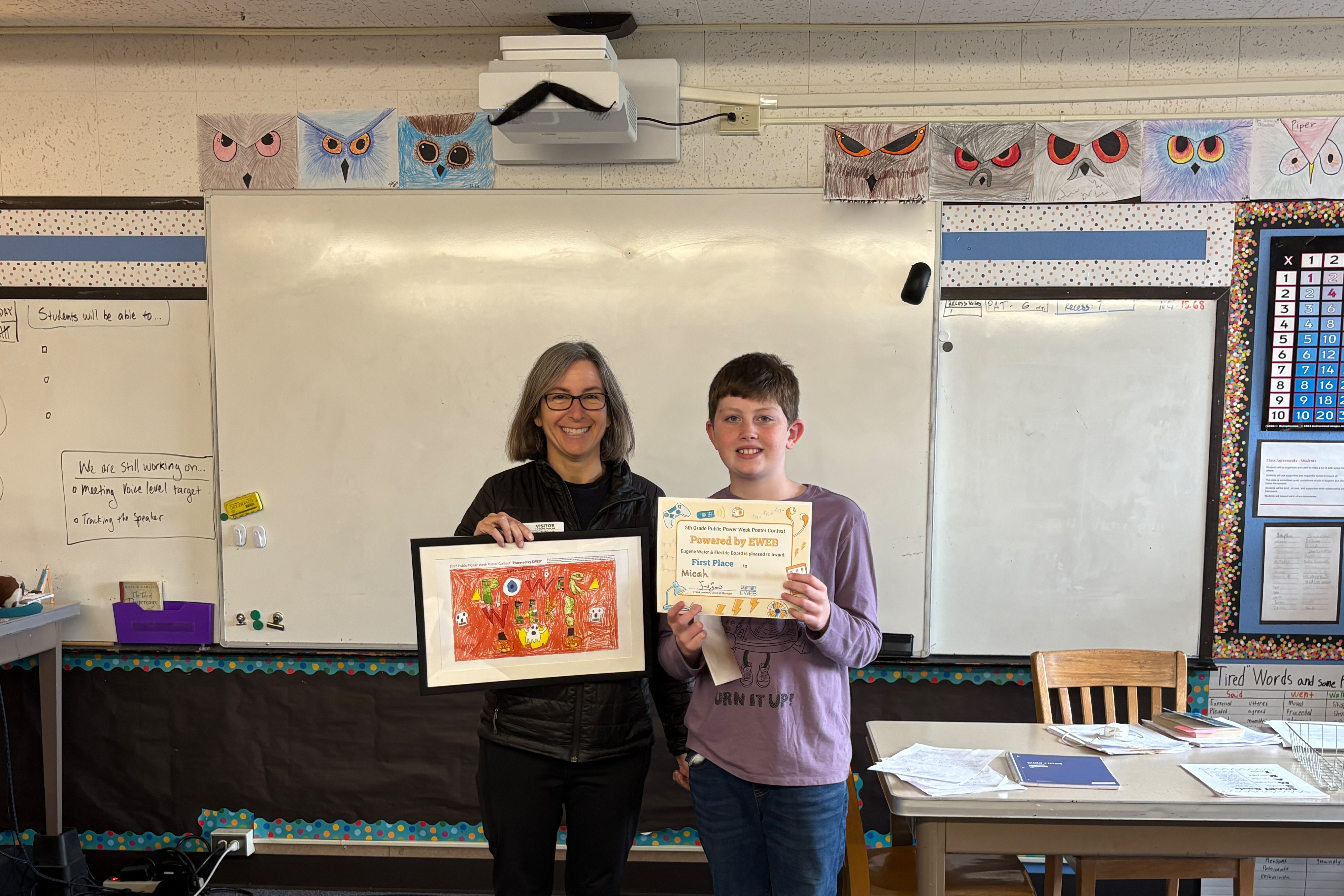 First place winner of EWEB's Public Power Week Poster Contest accepting their award.