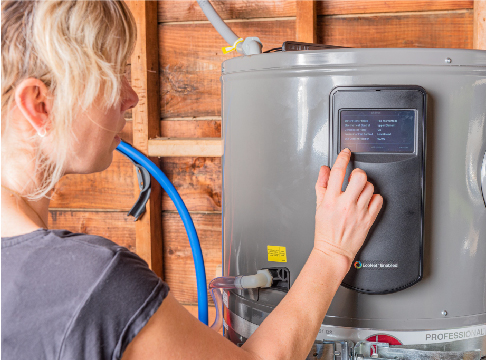 Woman interacting with control panel on a heat pump water heater