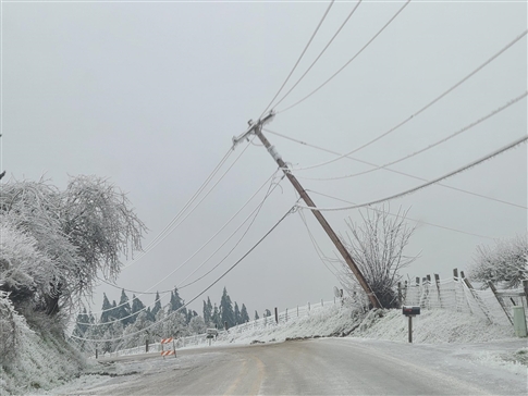 Winter storm pulls a power pole down on road