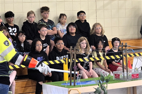 Children watch a live-voltage safety demo