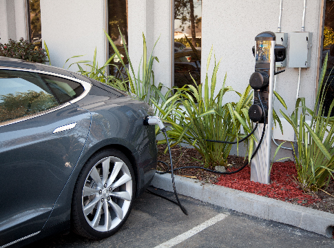 Electric car plugged in to a commercial charging station