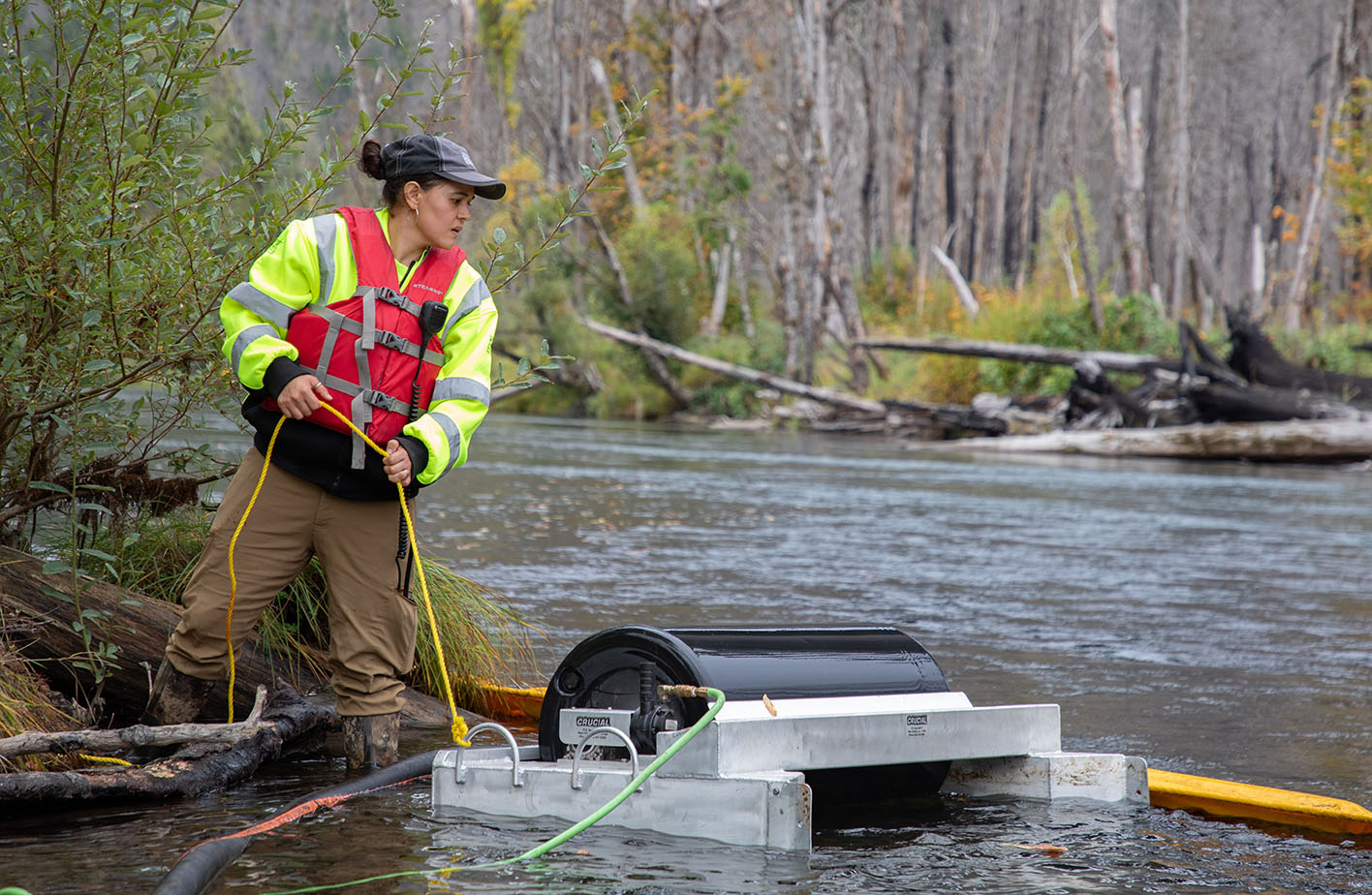 EWEB technician places oil skimmer as part of the spill drill